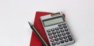 black and silver calculator beside black pen