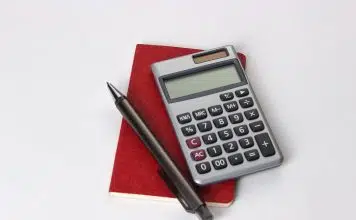 black and silver calculator beside black pen